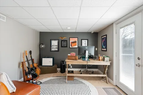 a living room with furniture a flat screen tv and a table