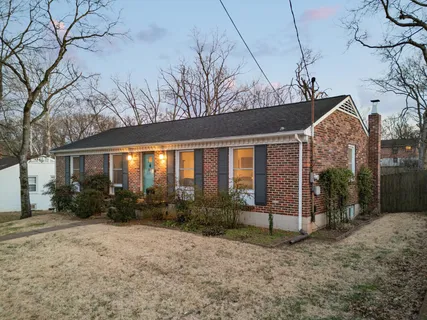 a view of a house with a small yard and potted plants