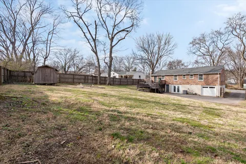 a view of a house with a yard covered with snow in the patio