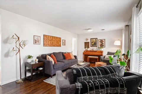a bedroom with furniture and wooden floor