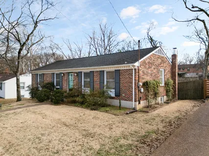 a front view of a house with garden and porch
