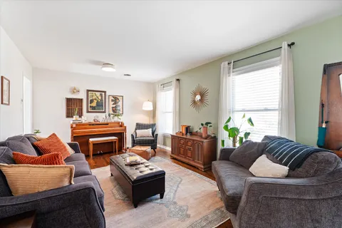 a living room with furniture a fireplace and a window