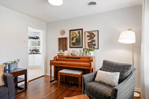 a living room with furniture and a piano