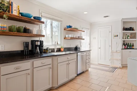 a kitchen with cabinets and chairs