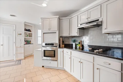 a kitchen with cabinets and appliances
