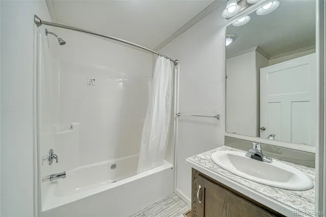a bathroom with a sink double vanity granite tub and shower