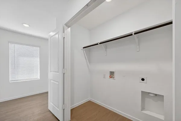 a view of a house with a yard and potted plants