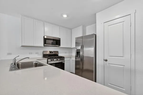 a kitchen with a refrigerator sink and microwave