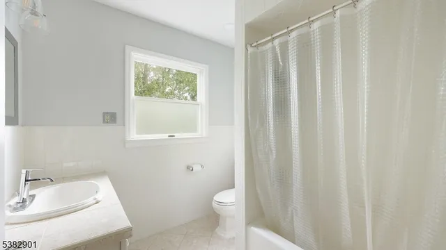 a bathroom with a sink a toilet and tub