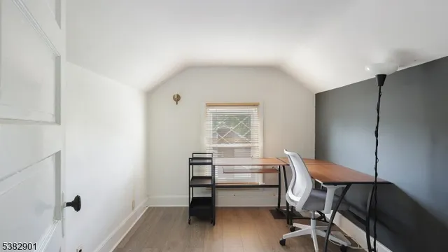 a view of a workspace with furniture and a window