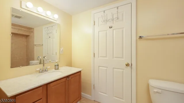 a bathroom with a granite countertop sink a mirror and a shower