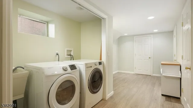 a view of storage and utility room with washer and dryer