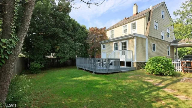 a view of a house with a yard and sitting area