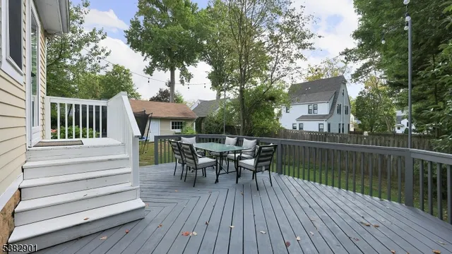 a view of a deck with table and chairs and wooden floor