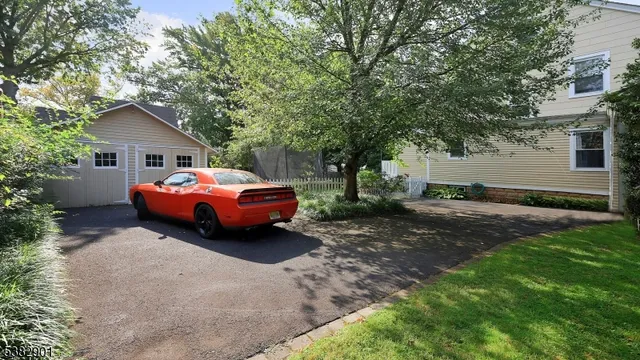 a car parked in front of white house