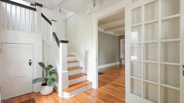 a view of entryway with wooden floor and front door