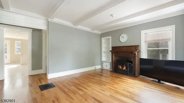 a view of empty room with window and fireplace