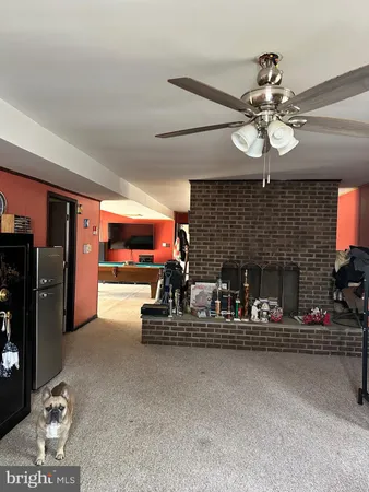 a view of an empty room with a fireplace and a window