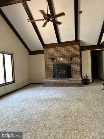 a view of an empty room with a fireplace