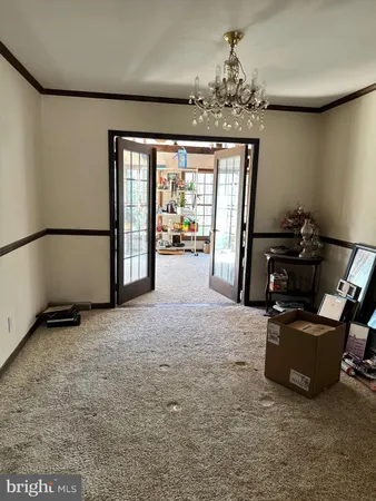a view of a livingroom with furniture and a window