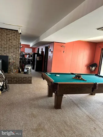 a room with pool table windows and outdoor view
