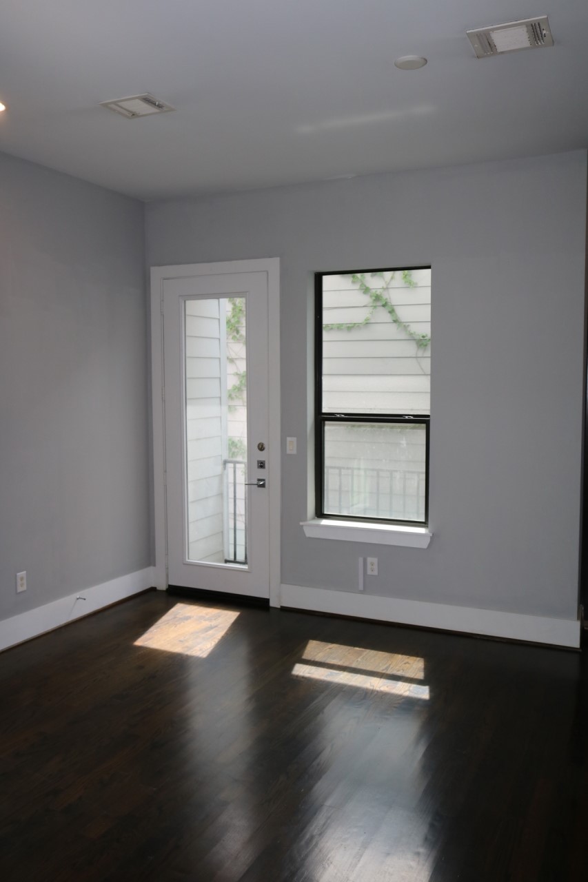2103 Hadley Street Houston, TX 77003 - Photo 7 of 19 a view of an empty room with wooden floor and a window