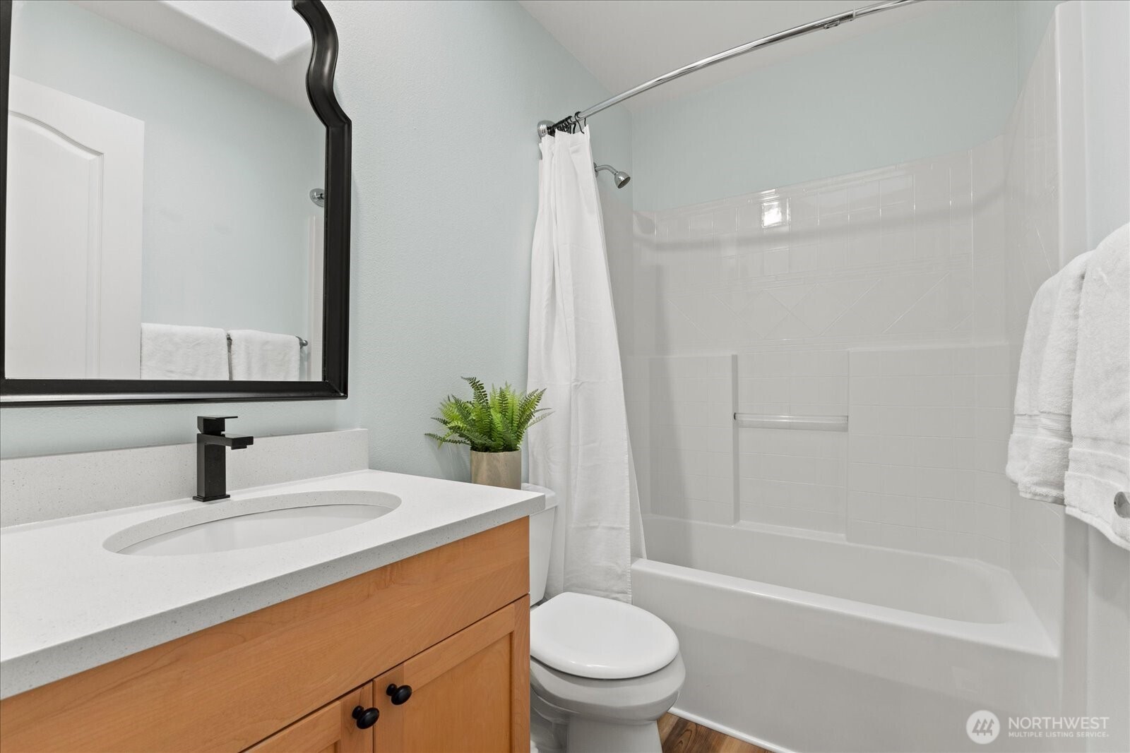 16526 Southeast 256th Street, Unit C3 Covington, WA 98042 - Photo 19 of 26 a bathroom with a sink a toilet a mirror a vanity and shower