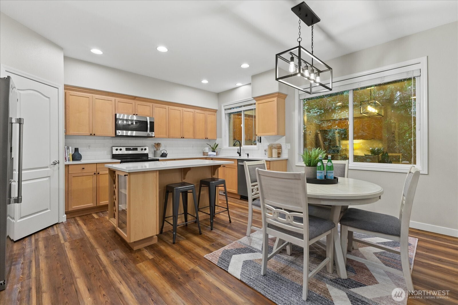 16526 Southeast 256th Street, Unit C3 Covington, WA 98042 - Photo 6 of 26 a kitchen with kitchen island granite countertop a sink a counter top space appliances and cabinets