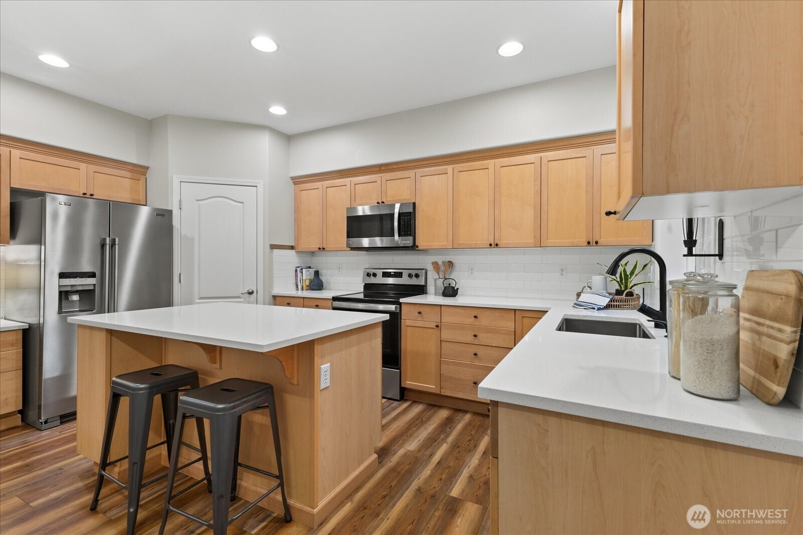 16526 Southeast 256th Street, Unit C3 Covington, WA 98042 - Photo 9 of 26 a kitchen that has a sink and a stove in it