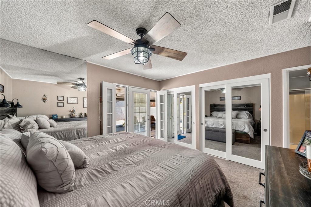 4040 Penrod Drive Riverside, CA 92505 - Photo 13 of 30 a spacious bedroom with a large bed and a chandelier