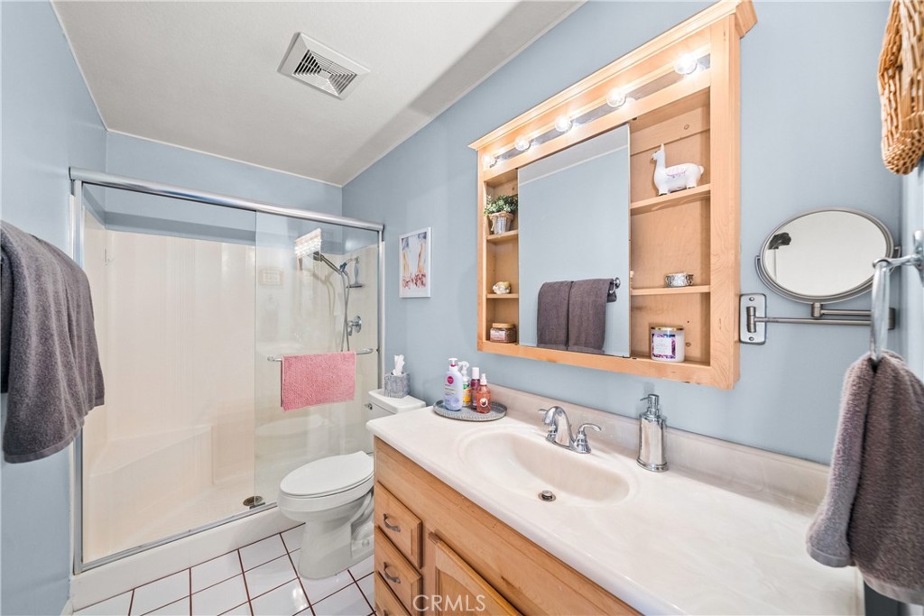 4040 Penrod Drive Riverside, CA 92505 - Photo 14 of 30 a bathroom with a sink vanity mirror and toilet