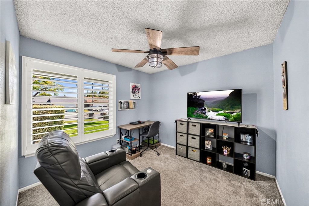 4040 Penrod Drive Riverside, CA 92505 - Photo 15 of 30 a living room with furniture and a flat screen tv