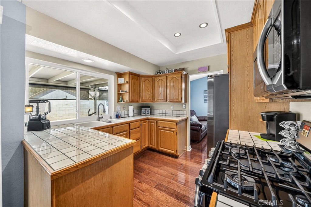 4040 Penrod Drive Riverside, CA 92505 - Photo 9 of 30 a kitchen with a stove and a wooden floors