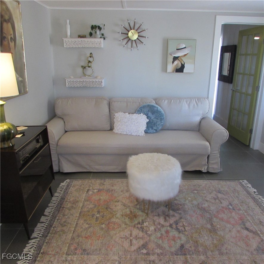 16111 Tortuga Street Bokeelia, FL 33922 - Photo 11 of 29 a living room with furniture and a window