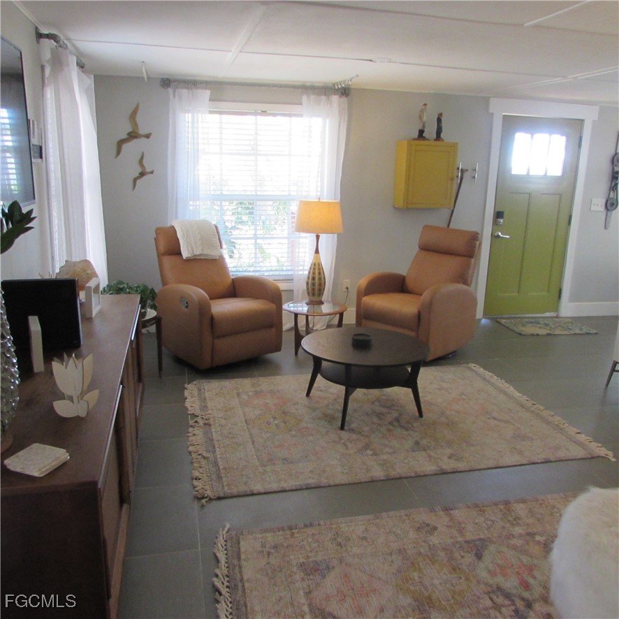 16111 Tortuga Street Bokeelia, FL 33922 - Photo 13 of 29 a living room with furniture and a window
