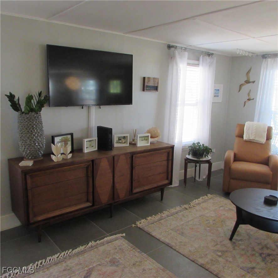 16111 Tortuga Street Bokeelia, FL 33922 - Photo 14 of 29 a living room with furniture and a flat screen tv
