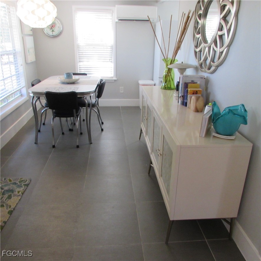 16111 Tortuga Street Bokeelia, FL 33922 - Photo 16 of 29 a view of a dining room with furniture and window
