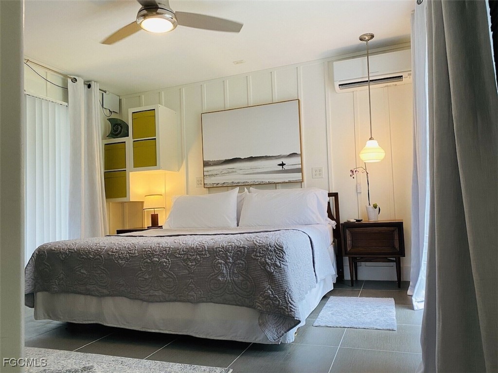 16111 Tortuga Street Bokeelia, FL 33922 - Photo 3 of 29 a bedroom with a bed and a chandelier