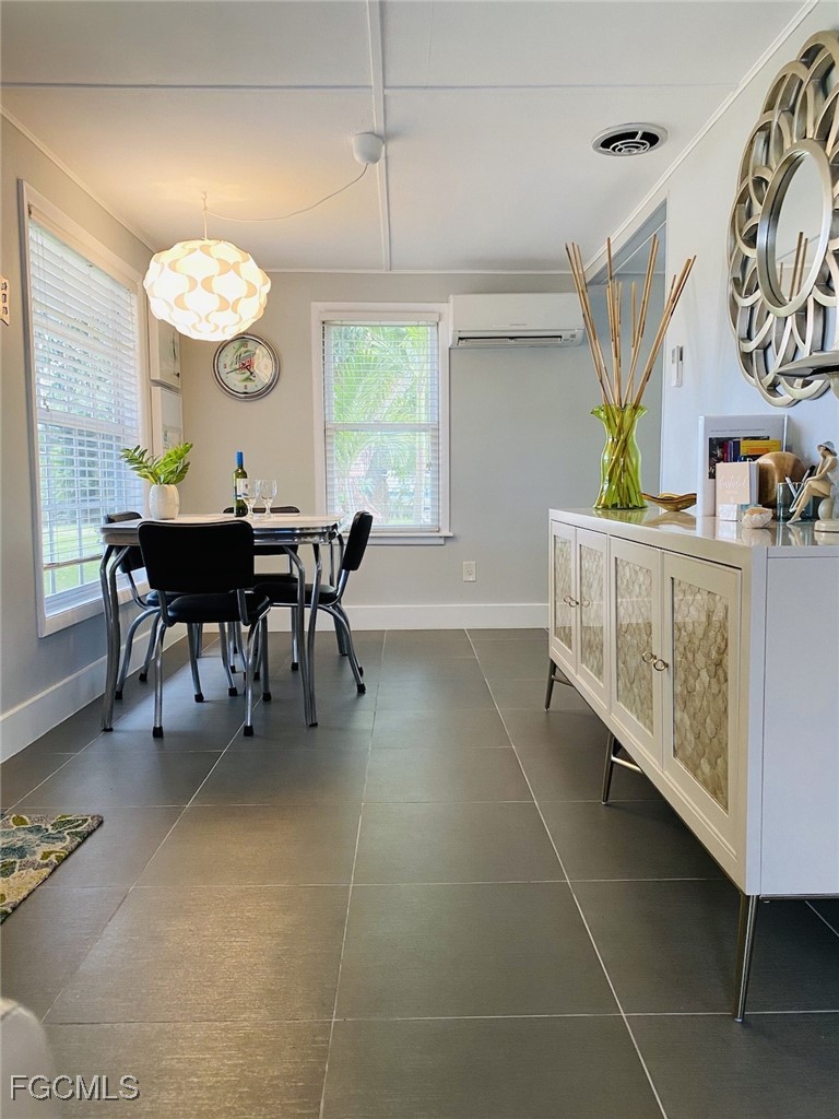 16111 Tortuga Street Bokeelia, FL 33922 - Photo 5 of 29 a view of a dining room and kitchen with furniture window and outside view