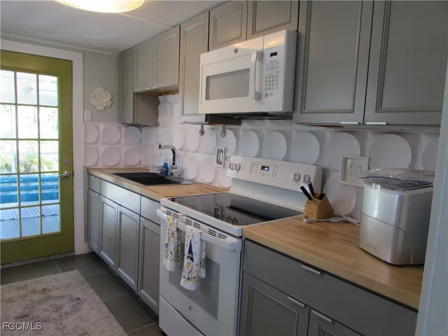 a kitchen with stainless steel appliances granite countertop a sink and a microwave
