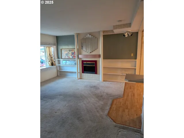 a view of a livingroom with furniture and a fireplace