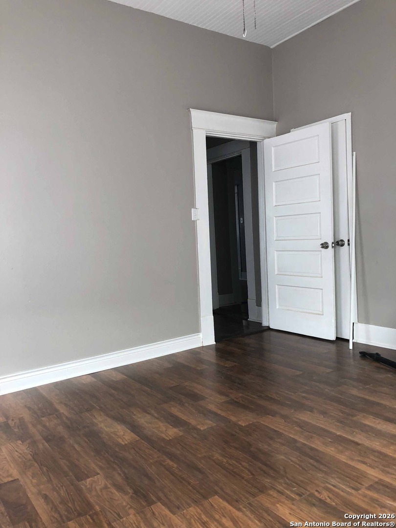 215 Rigsby Avenue San Antonio, TX 78210 - Photo 6 of 13 a view of an empty room with wooden floor and closet
