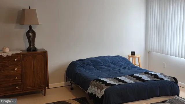 a bedroom with a bed and a night stand