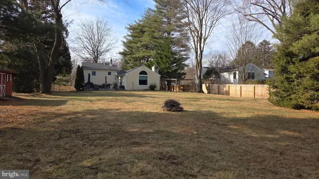 a view of a white house with a yard