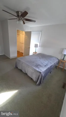 a bed sitting in a room next to a window