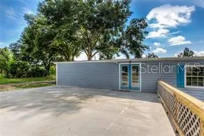a view of a house with backyard and tree