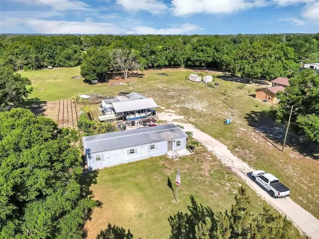 a view of swimming pool with outdoor seating and yard in the back