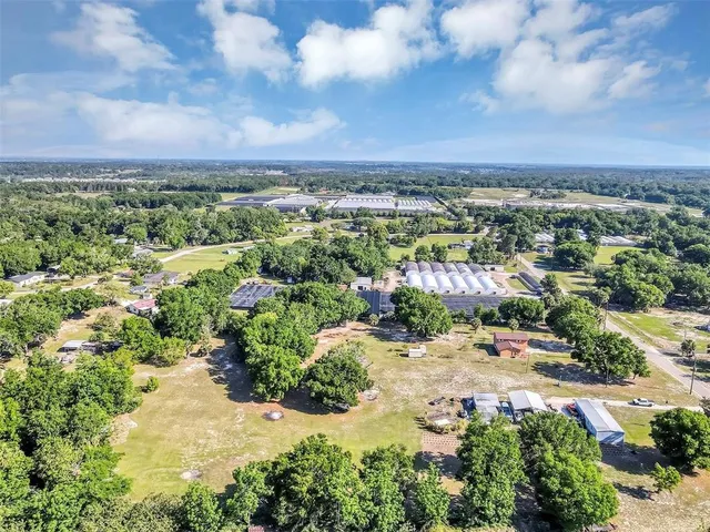 an aerial view of house with a yard