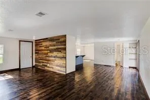 wooden floor in an empty room with a window