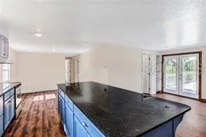 an open kitchen with granite countertop a sink window and refrigerator
